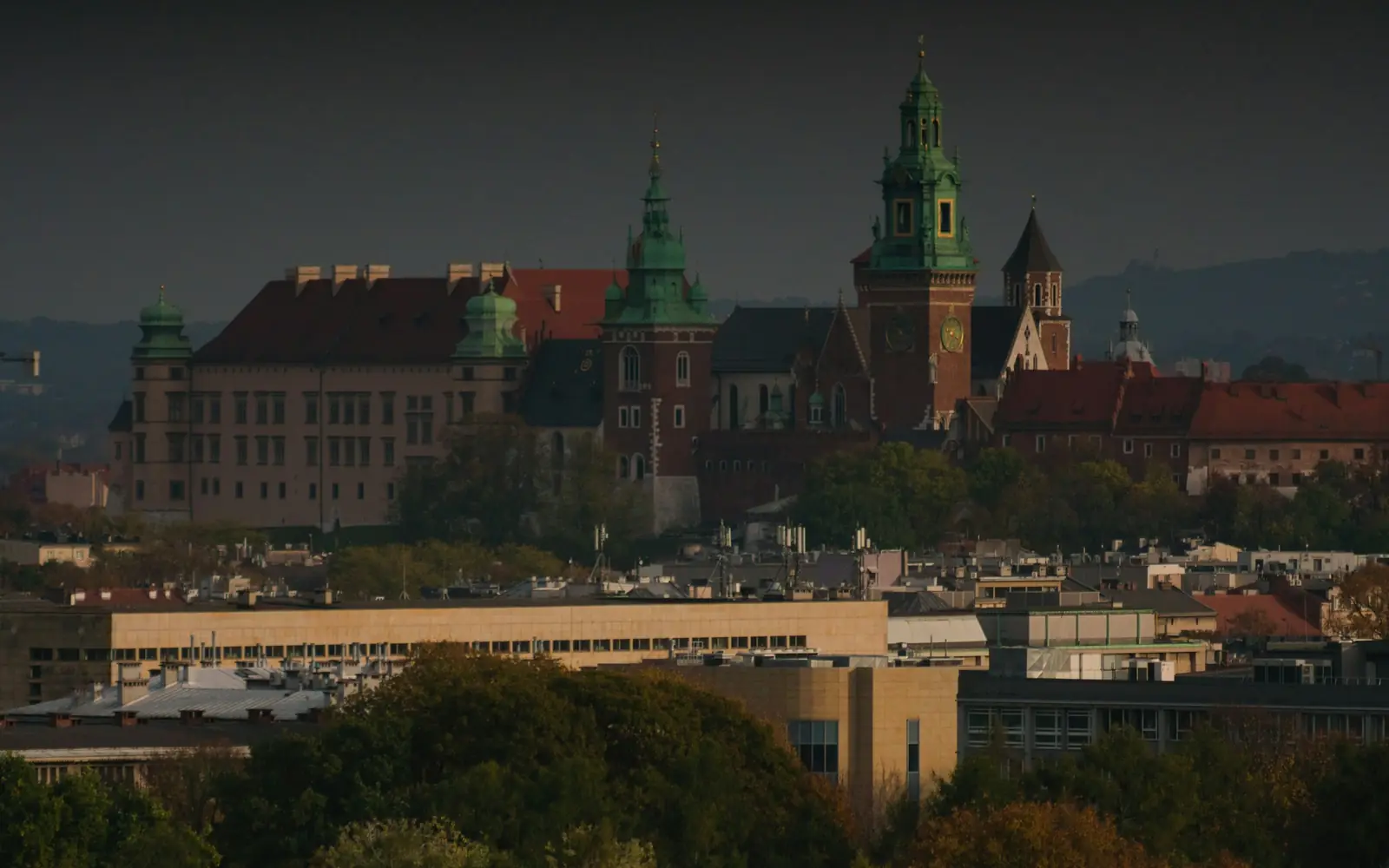 The Wawel skyline at dusk, towers and cathedral silhouetted over Kraków